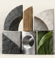 Two-tier architectural sculpture combining polished stone, circular aperture, bamboo and foliage
